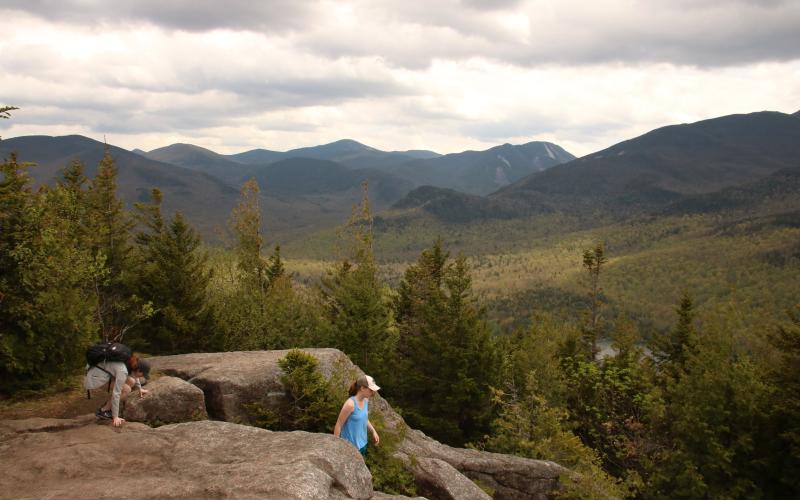 A family hiking a rock summit