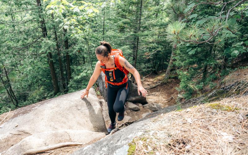 Hiker walks up rocky section of trail