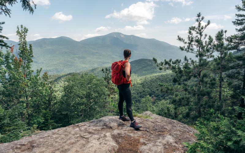 Hiker takes in the view from overlook near Rooster Comb summit