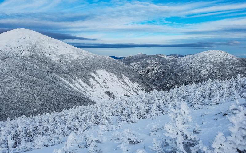 A view of snow-covered mountains under foreboding clouds