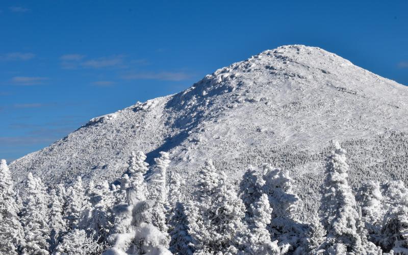 A large, domed, snow-capped peak