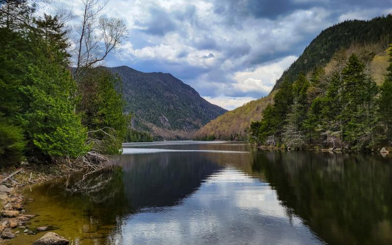 Water reflecting of steep mountain cliffs