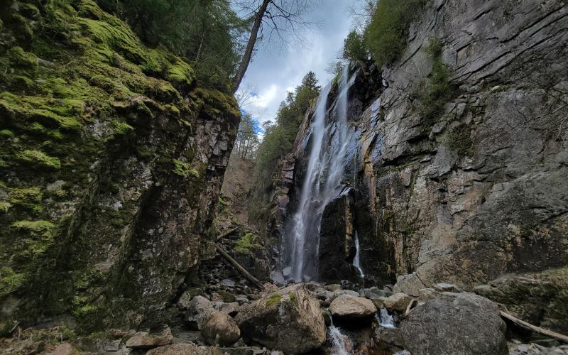 A tall waterfall in a narrow valley