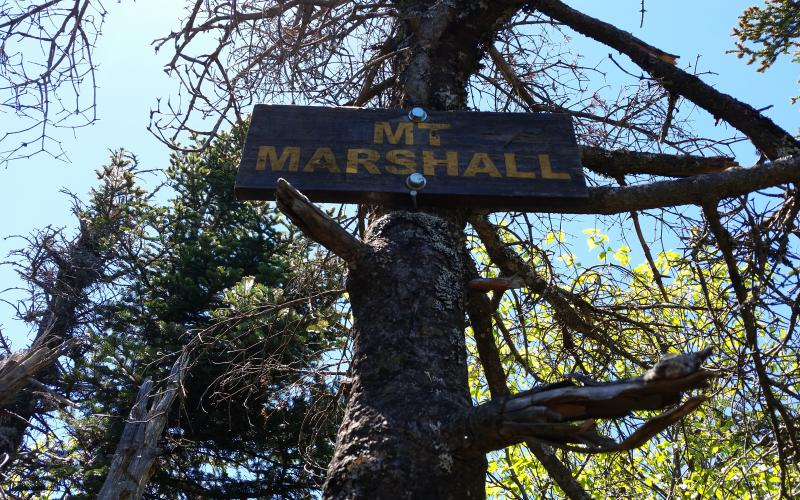 A wooden sign marking the summit of Mt Marshall