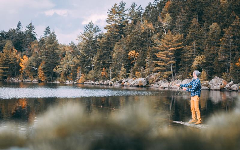 A person fishing in the fall