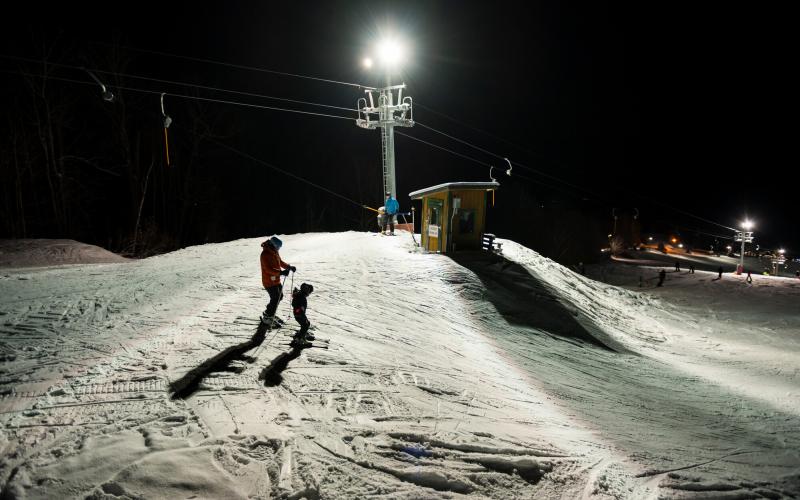 A couple skiers on Mt Pisgah at night