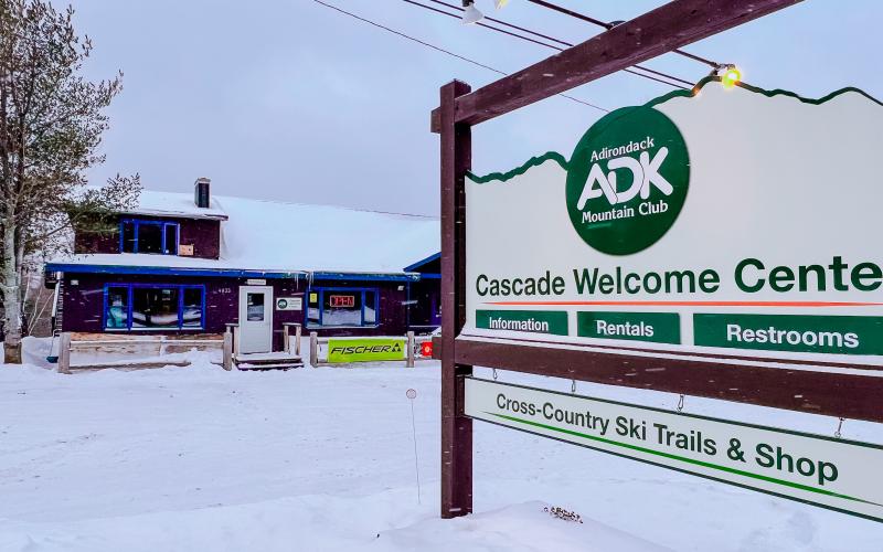 A wooden sign for Cascade Welcome Center