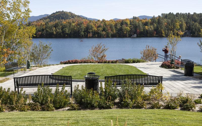 Park benches and green space at the edge of a lake