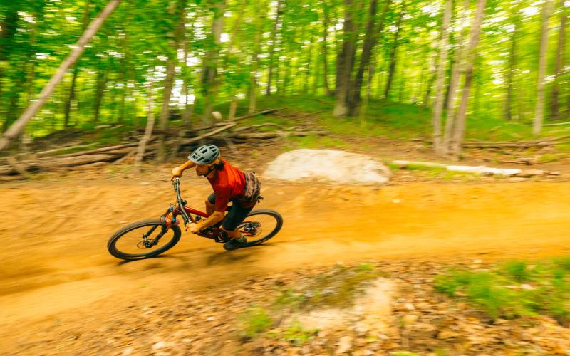 A mountain biker going around a berm