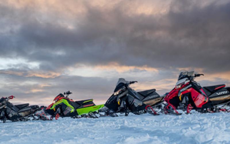 Fleet of snowmachines sit, ready for your next adventure