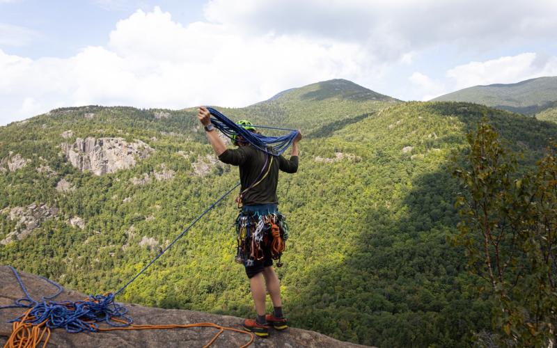 Man nests ropes to prepare for rock climbing