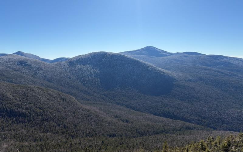 snow caresses the mountain tops