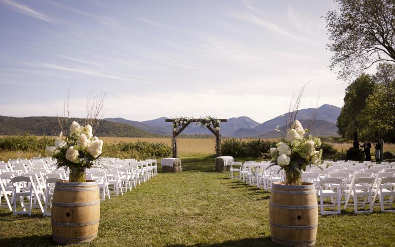 The wedding site with rustic alter adorned with hydrangeas and hay bales