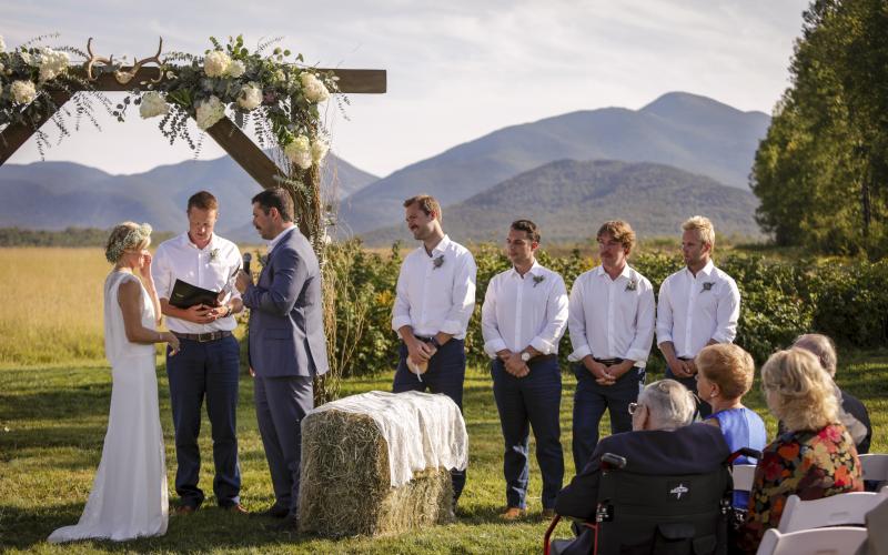 Bride and Groom at the alter with groomsmen and mountains surrounding.